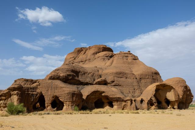 Caves pierce through sandstone blocks at the Garoa Hallagana rock art site, in Ennedi Ouest province, Chad, on July 10, 2025. A five-day scientific mission, conducted at the end of July, thirty kilometers from Fada, brought together Chadian archaeologists and geologists from the universities of N'Djamena and Abeche.
The objective: to lay "the first milestone" in the chronological markers of the ancient occupation of the Ennedi region, the researcher asserts.
The Ennedi Natural and Cultural Reserve (RNCE), created in 2018 in this Chadian province, at the crossroads with Libya and Sudan, is home to a rich archaeological heritage.
Across a sanctuary spanning more than 50,000 square kilometers, tens of thousands of rock engravings and paintings adorn the rock faces.
Following the inscription of the RNCE on the World Heritage List in 2016, the Chadian government entrusted its co-management to the South African NGO African Parks for fifteen years. (Photo by Joris Bolomey / AFP)