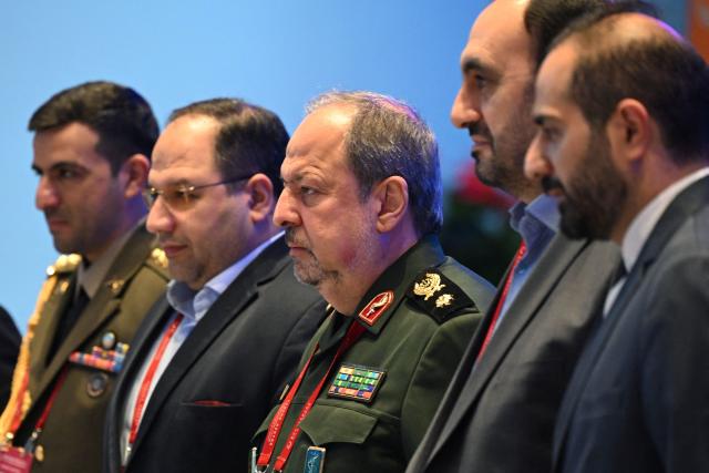 Iran’s Deputy Defence Minister Majid Ebnoreza (C) stands with delegation members before a a plenary session of the Xiangshan Forum in Beijing on September 19, 2025. (Photo by GREG BAKER / AFP)