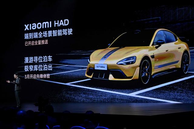 (FILES) Lei Jun, Chairman and CEO of Chinese electronics company Xiaomi, introduces the Xiaomi SU7 Ultra electric car model, in Beijing on February 27, 2025. Chinese consumer tech giant Xiaomi will remotely fix a flaw in the assisted driving system on over 110,000 of its popular SU7 electric cars, the firm and regulators said on September 19, 2025, months after a deadly crash involving the model. (Photo by Pedro PARDO / AFP)