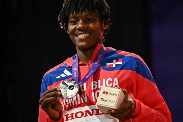 Silver medallist Dominican Republic's athlete Marileidy Paulino celebrates with her medal on the podium for the women's 400m during the World Athletics Championships in Tokyo on September 19, 2025. (Photo by Philip FONG / AFP)