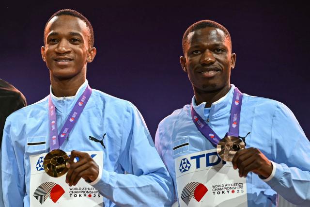 (from L) Gold medallist Botswana's Busang Collen Kebinatshipi and Bronze medallist Botswana's Bayapo Ndori celebrate with medals on the podium for the men's 400m during the World Athletics Championships in Tokyo on September 19, 2025. (Photo by Philip FONG / AFP)