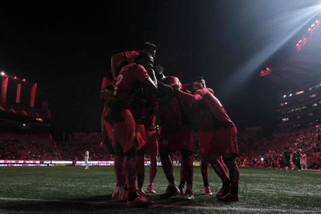 Tijuana's Jamaican midfielder #09 Shamar Nicholson (unseen) celebrates with teammates after scoring his team's fifth goal during the Liga MX Apertura tournament football match between Tijuana and Leon at the Caliente Stadium in Tijuana, Baja California, Mexico on September 19, 2025. (Photo by Guillermo Arias / AFP)