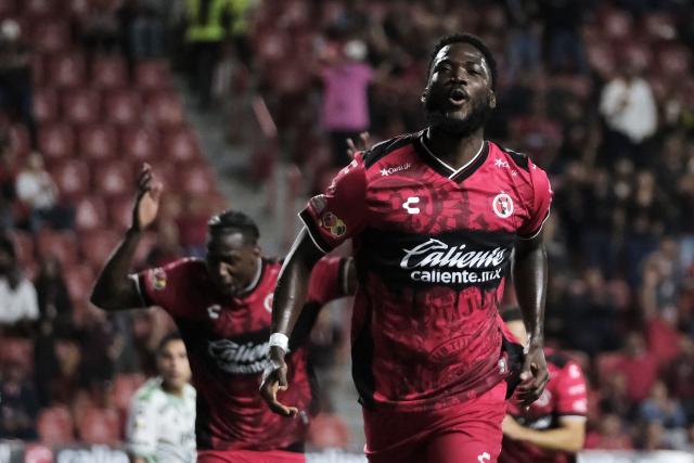 TOPSHOT - Tijuana's Jamaican midfielder #09 Shamar Nicholson celebrates scoring his team's fifth goal during the Liga MX Apertura tournament football match between Tijuana and Leon at the Caliente Stadium in Tijuana, Baja California, Mexico on September 19, 2025. (Photo by Guillermo Arias / AFP)