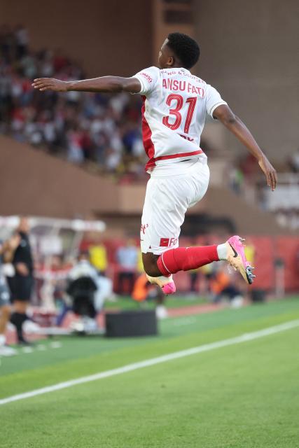 Monaco's Spanish forward #31 Ansu Fati leaps in the air as he celebrates scoring Monaco's fourth goal during the French L1 football match between AS Monaco and FC Metz at the Louis II Stadium (Stade Louis II) in the Principality of Monaco, on September 21, 2025. (Photo by Valery HACHE / AFP)