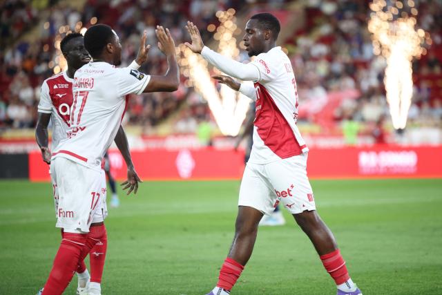 Monaco's French forward #19 George Ilenikhena (R) celebrates with Monaco's Belgian midfielder #17 Stanis Idumbo (2L) after scoring Monaco's fifth goal during the French L1 football match between AS Monaco and FC Metz at the Louis II Stadium (Stade Louis II) in the Principality of Monaco, on September 21, 2025. (Photo by Valery HACHE / AFP)
