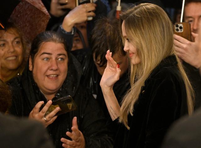 US actress Angelina Jolie greets fans as she arrives for the photocall of the film "Couture" during the 73rd San Sebastian International Film Festival in the northern Spanish Basque city of San Sebastian on September 21, 2025. (Photo by ANDER GILLENEA / AFP)
