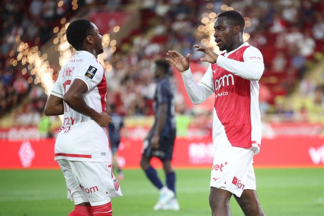 Monaco's French forward #19 George Ilenikhena (R) celebrates with Monaco's Belgian midfielder #17 Stanis Idumbo (L) after scoring Monaco's fifth goal during the French L1 football match between AS Monaco and FC Metz at the Louis II Stadium (Stade Louis II) in the Principality of Monaco, on September 21, 2025. (Photo by Valery HACHE / AFP)