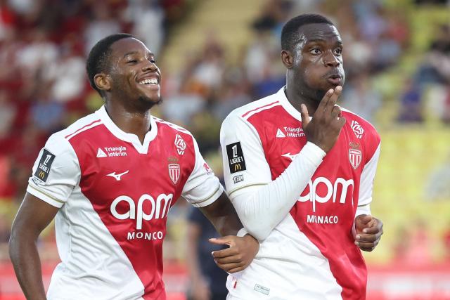 Monaco's French forward #19 George Ilenikhena (R) celebrates after scoring a goal during the French L1 football match between AS Monaco and FC Metz at the Louis II Stadium (Stade Louis II) in the Principality of Monaco on September 21, 2025. (Photo by Valery HACHE / AFP)