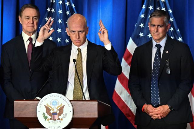 US Representative Adam Smith (C), Democratic ranking member of the House Armed Services Committee speaks flanked by US Ambassador to China David Perdue (L) and Michael Baumgartner, Republican member of House Foreign Affairs Committee during a press conference at the US embassy in Beijing on September 23, 2025. (Photo by Pedro PARDO / AFP)