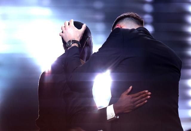 Paris Saint-Germain's French forward Ousmane Dembele (L) is congratuled by his former teammate Italy's goalkeeper Gianluigi Donnarumma after receiving the Ballon d'Or award during the 2025 Ballon d'Or France Football award ceremony at the Theatre du Chatelet in Paris on September 22, 2025. (Photo by FRANCK FIFE / AFP)