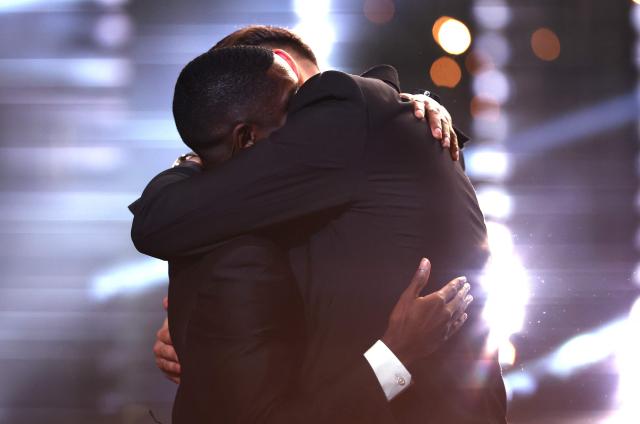 Paris Saint-Germain's French forward Ousmane Dembele (L) is congratuled by his former teammate Italy's goalkeeper Gianluigi Donnarumma after receiving the Ballon d'Or award during the 2025 Ballon d'Or France Football award ceremony at the Theatre du Chatelet in Paris on September 22, 2025. (Photo by FRANCK FIFE / AFP)