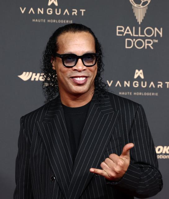 Brazilian former football player Ronaldinho poses upon arrival before the 2025 Ballon d'Or France Football award ceremony at the Theatre du Chatelet in Paris on September 22, 2025. (Photo by FRANCK FIFE / AFP)