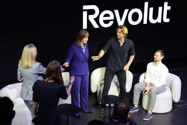 Britain's Chancellor of the Exchequer Rachel Reeves (C), Revolut bank's CEO Nikolay Storonsky (2R) and Revolut bank's Chief Technology Officer, Vlad Yatsenko, take part in an event to open Revolut's new global headquarters in the Canary wharf financial district of east London, on September 23, 2025. (Photo by Adrian DENNIS / AFP)