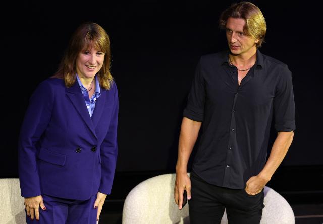 Britain's Chancellor of the Exchequer Rachel Reeves (C) and Revolut bank's CEO Nikolay Storonsky take part in an event to open Revolut's new global headquarters in the Canary wharf financial district of east London, on September 23, 2025. (Photo by Adrian Dennis / AFP)