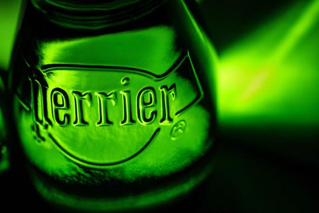 (FILES) This picture shows a close up of a Perrier sparkling water bottle in Quimper, western France, on May 20, 2025. On September 24, 2025 morning, the French consumer association, UFC-Que Choisir, will ask the Nanterre court to temporarily withdraw Perrier bottles, a Nestle Waters brand, considering their marketing as "natural mineral water" to be misleading (Photo by Fred TANNEAU / AFP)
