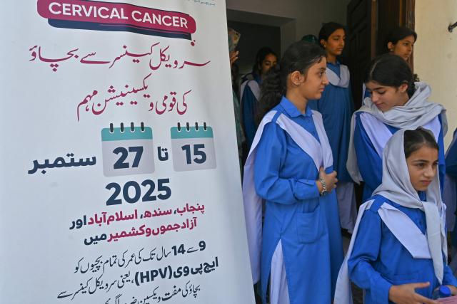 School students leave after receiving human papillomavirus (HPV) vaccine by health workers in Islamabad on September 24, 2025, during a vaccination drive held to protect adolescent girls from cervical cancer. (Photo by Farooq NAEEM / AFP)