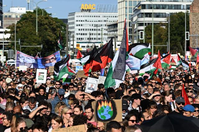 Participants march during a demonstration under the motto 'Draw the red line with us: Together for Gaza!' in Berlin on September 27, 2025. (Photo by RALF HIRSCHBERGER / AFP)