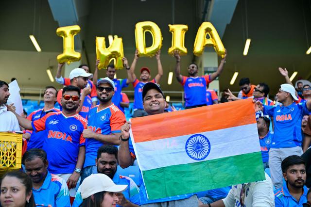 Indian fans cheer before the start of the Asia Cup 2025 Twenty20 international cricket final match between India and Pakistan at the Dubai International Stadium in Dubai on September 28, 2025. (Photo by Sajjad HUSSAIN / AFP)