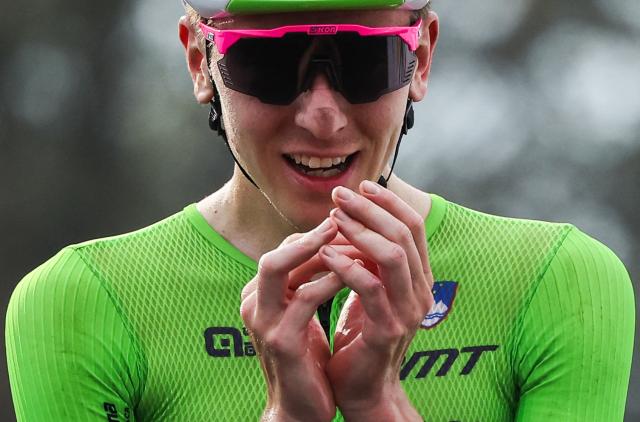 Slovenian rider Tadej Pogacar celebrates after winning the men's Elite road race cycling event during the UCI 2025 Road World Championships, in Kigali, on September 28, 2025. (Photo by Anne-Christine POUJOULAT / AFP)