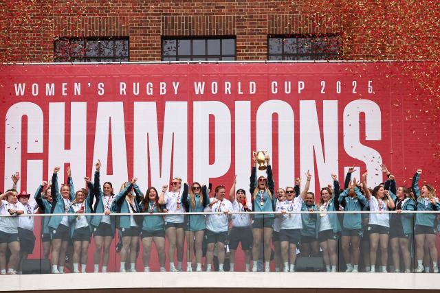 England's captain Zoe Aldcroft lifts the trophy as England players celebrate at a Red Roses Champions Party, held at Battersea Power Station in central London on September 28, 2025, after their win in the final of the Women’s Rugby World Cup against Canada the previous day. England coach insisted the Red Roses could "dominate the world for a long time" after their 33-13 win over Canada in the Women's Rugby World Cup final at Twickenham on Saturday. (Photo by HENRY NICHOLLS / AFP)