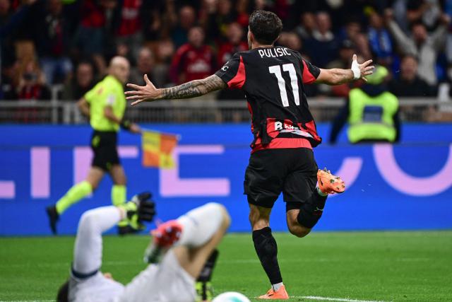 AC Milan's US forward #11 Christian Pulisic (R) celebrates after scoring his team's second goal during the Italian Serie A football match between AC Milan and SSC Napoli at San Siro stadium in Milan, northern Italy, on September 28, 2025. (Photo by Piero CRUCIATTI / AFP)