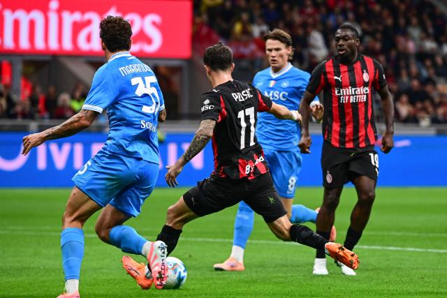 AC Milan's US forward #11 Christian Pulisic (C) kicks and scores his team's second goal during the Italian Serie A football match between AC Milan and SSC Napoli at San Siro stadium in Milan, northern Italy, on September 28, 2025. (Photo by Piero CRUCIATTI / AFP)