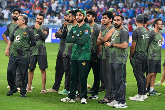 Pakistan's cricket team members wait for the presentation ceremony at the end of the Asia Cup 2025 Twenty20 international cricket final match between India and Pakistan at the Dubai International Stadium in Dubai on September 28, 2025. (Photo by Sajjad HUSSAIN / AFP)