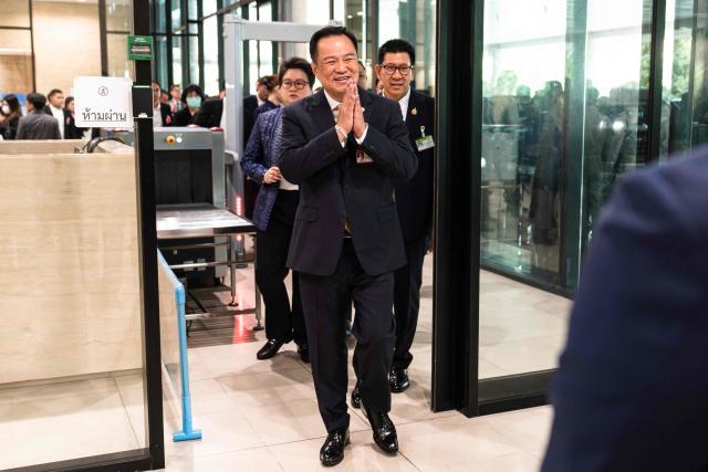 Thailand's Prime Minister Anutin Charnvirakul gestures as he arrives at parliament in Bangkok on September 29, 2025. (Photo by Chanakarn Laosarakham / AFP)
