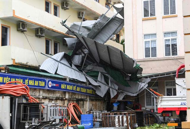 This picture shows a corrugated iron roof blown off after typhoon Bualoi made a landfall in Nghe An province on September 29, 2025. Vietnam said it evacuated almost 30,000 residents from coastal areas on September 28, as Typhoon Bualoi hit the country's steel-producing central belt. (Photo by Thai An / AFP)