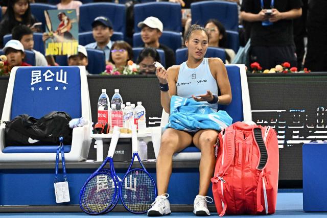 China’s Zheng Qinwen gestures as she rests during her women’s singles match against Czech Republic’s Linda Noskova at the China Open tennis tournament in Beijing on September 29, 2025. (Photo by Pedro Pardo / AFP)