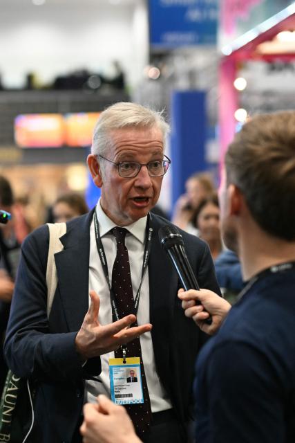 Former Conservative cabinet minister Michael Gove is interviewed on the floor on the second day of the annual Labour Party conference in Liverpool, north-west England, on September 29, 2025. The four-day gathering in Liverpool, comes amid chatter about a possible leadership challenge and follows two recent high-profile departures from his government. The conference, which ends on Wednesday, takes place with Labour lagging well behind the upstart anti-immigrant Reform UK party, in national surveys. (Photo by Oli SCARFF / AFP)