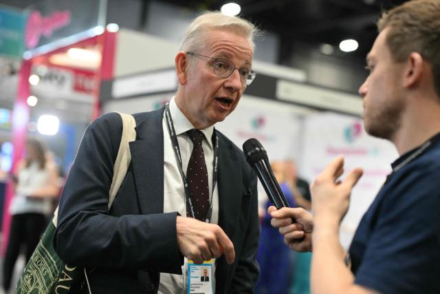 Former Conservative cabinet minister Michael Gove is interviewed on the floor on the second day of the annual Labour Party conference in Liverpool, north-west England, on September 29, 2025. The four-day gathering in Liverpool, comes amid chatter about a possible leadership challenge and follows two recent high-profile departures from his government. The conference, which ends on Wednesday, takes place with Labour lagging well behind the upstart anti-immigrant Reform UK party, in national surveys. (Photo by Oli SCARFF / AFP)