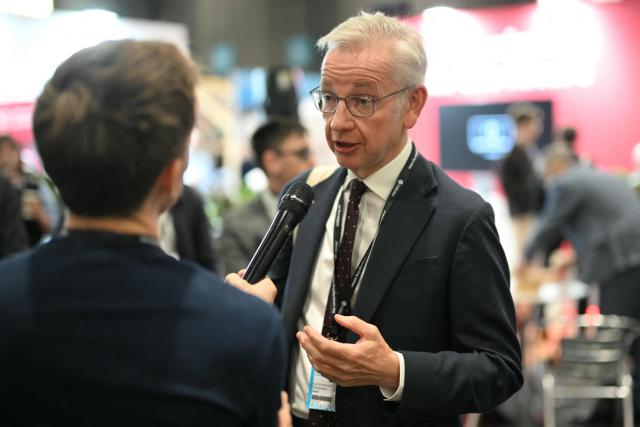 Former Conservative cabinet minister Michael Gove is interviewed on the floor on the second day of the annual Labour Party conference in Liverpool, north-west England, on September 29, 2025. The four-day gathering in Liverpool, comes amid chatter about a possible leadership challenge and follows two recent high-profile departures from his government. The conference, which ends on Wednesday, takes place with Labour lagging well behind the upstart anti-immigrant Reform UK party, in national surveys. (Photo by Oli SCARFF / AFP)