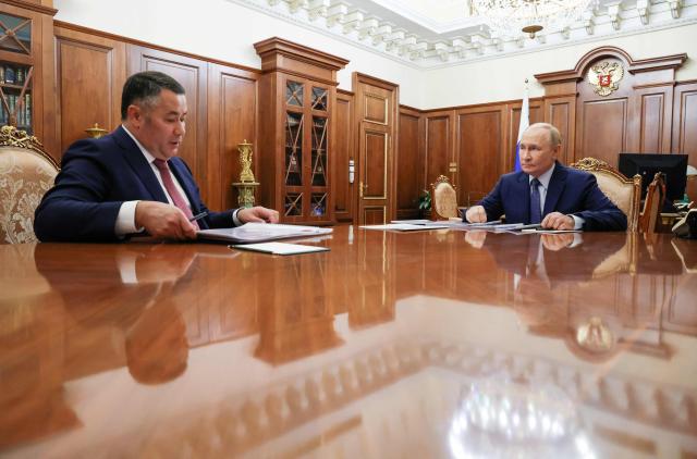 In this pool photograph distributed by the Russian state agency Sputnik, Russia's President Vladimir Putin (R) meets with the Governor of the Tver Region Igor Rudenya in Moscow on September 29, 2025. (Photo by Alexander KAZAKOV / POOL / AFP)