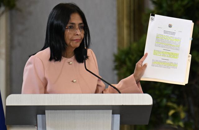 Venezuela's Vice President Delcy Rodriguez holds a document as she speaks during a meeting with accredited diplomatic representatives in Caracas on September 29, 2025. Venezuelan President Nicolas Maduro is ready to declare a state of emergency over the threat of US "aggression" following a spate of deadly US strikes on suspected Venezuelan drug boats, Vice President Delcy Rodriguez said on Monday. (Photo by Juan BARRETO / AFP)