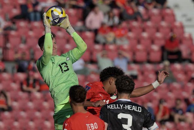 New Zeland's goalkeeper #13 Henry Gray catches the ball past Egypt's defender #02 Tebo Gabriel, New Zeland's defender #03 Lukas Kelly-Heald, and Egypt's forward #11 Hamed Abdallah (back) during the 2025 FIFA U20 World Cup football match between Egypt and New Zealand at the National Stadium in Santiago on September 30, 2025. (Photo by Rodrigo ARANGUA / AFP)