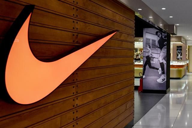 (FILES) The Nike logo is seen at a shopping mall in Hanoi July 3, 2025. Nike reported a surprise increase in quarterly sales September 30, 2025, pointing to progress on a turnaround as it forecast a bigger cost hit from US tariffs. Shares of the sports giant jumped in after hours-trading as Nike executives said their strategic pivot -- branded as "Win Now" -- was beginning to see greater success. (Photo by Nhac NGUYEN / AFP)