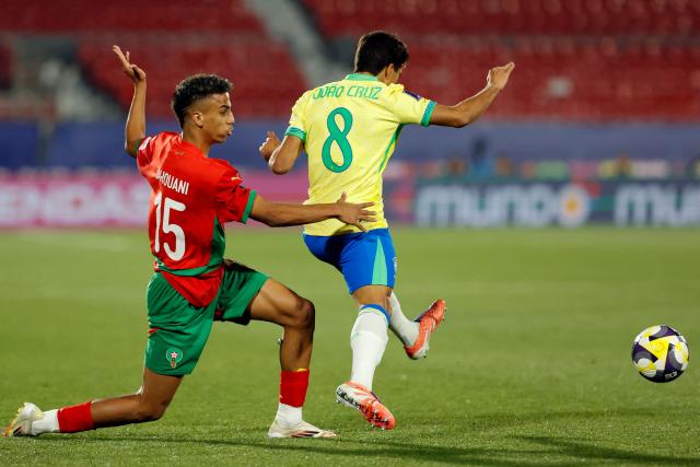 Morocco's defender #15 Fouad Zahouani and Brazil's midfielder #08 Joao Cruz fight for the ball during the 2025 FIFA U-20 World Cup football match between Brazil and Morocco at the National Stadium in Santiago on October 1, 2025. (Photo by Raul BRAVO / AFP)