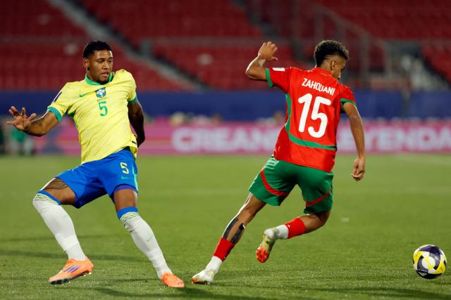 Brazil's midfielder #05 Rayan Lucas and Morocco's defender #15 Fouad Zahouani fight for the ball during the 2025 FIFA U-20 World Cup football match between Brazil and Morocco at the National Stadium in Santiago on October 1, 2025. (Photo by Raul BRAVO / AFP)