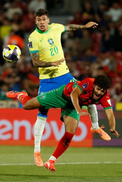 Brazil's midfielder #20 Erick Bele and Morocco's defender #4 Ismael Baouf fight for the ball during the 2025 FIFA U-20 World Cup football match between Brazil and Morocco at the National Stadium in Santiago on October 1, 2025. (Photo by Raul BRAVO / AFP)