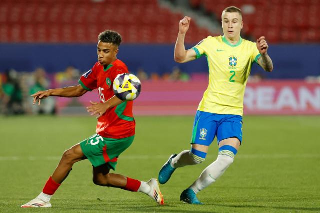 Morocco's defender #15 Fouad Zahouani and Brazil's defender #02 Igor fight for the ball during the 2025 FIFA U-20 World Cup football match between Brazil and Morocco at the National Stadium in Santiago on October 1, 2025. (Photo by Raul BRAVO / AFP)