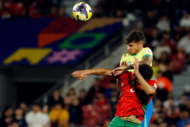Brazil's midfielder #08 Joao Cruz and Morocco's defender #4 Ismael Baouf fight for the ball during the 2025 FIFA U-20 World Cup football match between Brazil and Morocco at the National Stadium in Santiago on October 1, 2025. (Photo by Raul BRAVO / AFP)