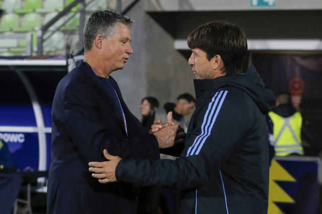 Australia's head coach Trevor Morgan (L) shakes hands with Argentina's head coach Diego Placente during the 2025 FIFA U-20 World Cup football match between Argentina and Australia at the Elias Figueroa Stadium in Valparaiso, Chile on October 1, 2025. (Photo by JAVIER TORRES / AFP)