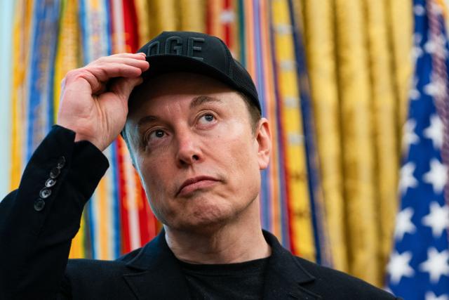 (FILES) Elon Musk looks on during a news conference with US President Donald Trump in the Oval Office of the White House in Washington, DC, on May 30, 2025. Billionaire Elon Musk, the world's richest person, is nearly halfway to becoming the planet's first trillionaire, Forbes magazine reported on October 1, 2025. (Photo by Allison ROBBERT / AFP)