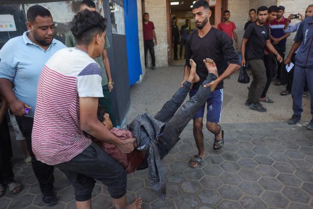 Palestinians transport casualties of a reported Israeli drone attack in Deir al-Balah, to Al-Aqsa Martyrs Hospital in the central Gaza Strip on October 2, 2025. Israel's defence minister issued a final warning for residents in Gaza City to flee south on October 1, as the Palestinian Hamas movement weighed the latest US plan to end the war in the besieged Palestinian territory. (Photo by BASHAR TALEB / AFP)