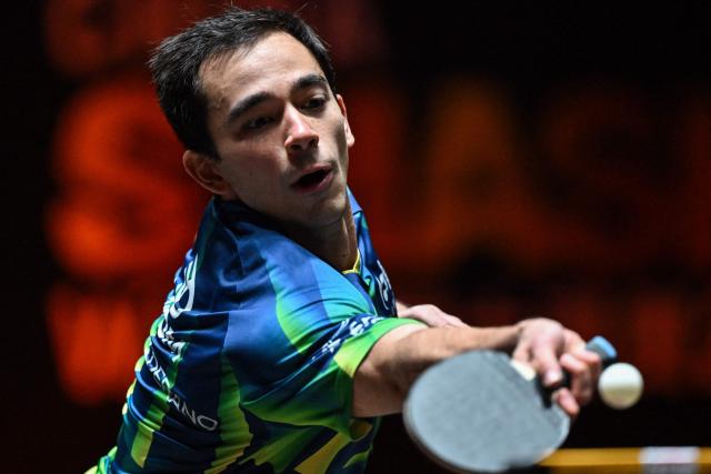 Brazil’s Hugo Calderano hits a return to China’s Zhou Qihao during their men’s singles match at the China Smash Table Tennis tournament in Beijing on October 2, 2025. (Photo by ADEK BERRY / AFP)