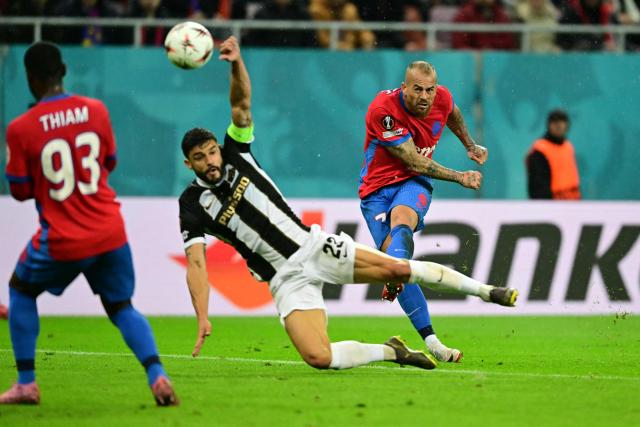 Steaua Bucharest's Romanian forward #07 Denis Alibec (R) kicks the ball past Young Boys' Swiss defender #23 Loris Benito (C) during the UEFA Europa League first round day 2 football match FC Steaua Bucharest v Young Boys in Bucharest on October 2, 2025. (Photo by Daniel MIHAILESCU / AFP)
