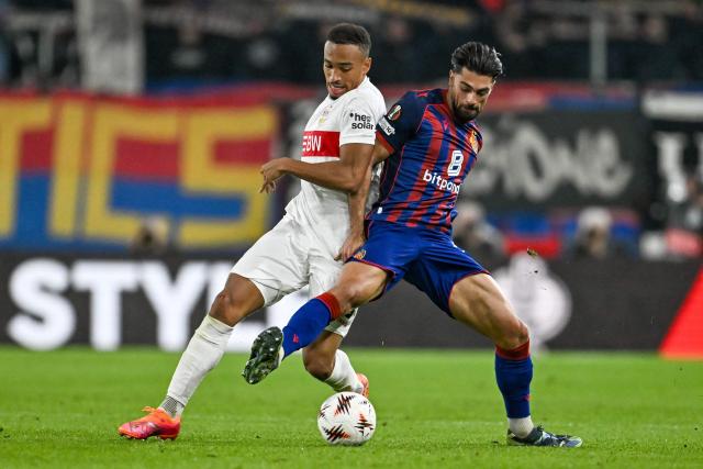 VfB Stuttgart's German forward #18 Jamie Leweling and Basel's Swiss defender #03 Nicolas Vouilloz vie for the ball during the UEFA Europa League first round day 2 football match between Basel and Stuttgart at St. Jakob-Park stadium in Basel on October 2, 2025. (Photo by Fabrice COFFRINI / AFP)