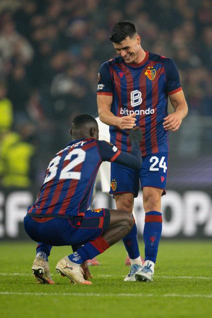 Basel's Ghanaian defender #32 Jonas Adjei Adjetey and Basel's Austrian defender #24 Flavius Daniliuc celebrates their victory at the end of the UEFA Europa League first round day 2 football match between Basel and Stuttgart at St. Jakob-Park stadium in Basel on October 2, 2025. (Photo by Fabrice COFFRINI / AFP)