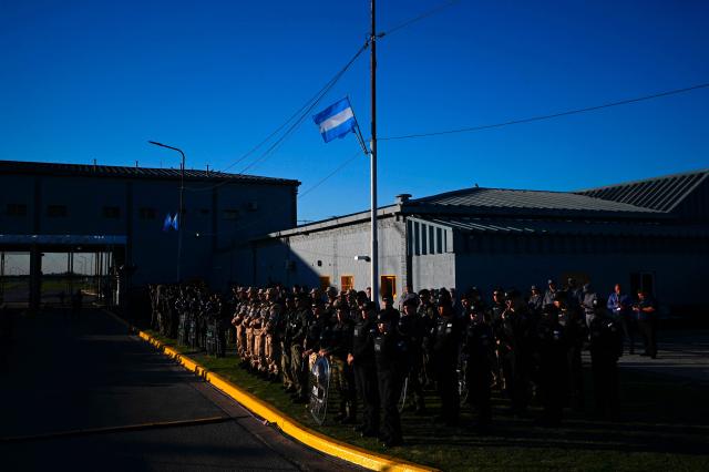 Members of Argentina's security forces listen to President Javier Milei's speech during the official presentation of a comprehensive reform bill for the Penal Code at Federal Penitentiary Complex No. 1 in Ezeiza, Buenos Aires province, on October 2, 2025. (Photo by Luis ROBAYO / AFP)